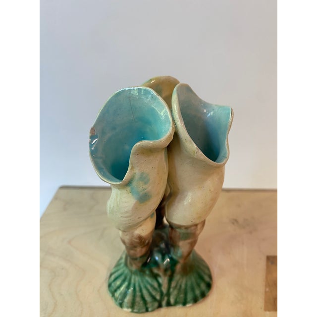 Antique majolica miniature ceramic vase. Features three pale yellow conch shell or floral forms, and a shell pattern at...