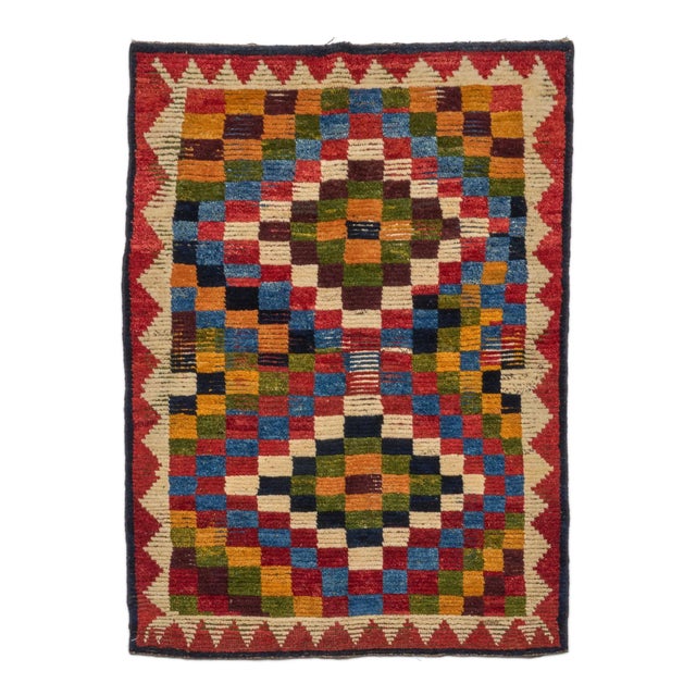 This 4x5 antique Persian Gabbeh rug is a charming addition to Rug & Kilim's rug collection. Hand-knotted in wool and...