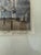 The image shows an antique black-and-white architectural etching in a dark wood frame, depicting a traditional European...