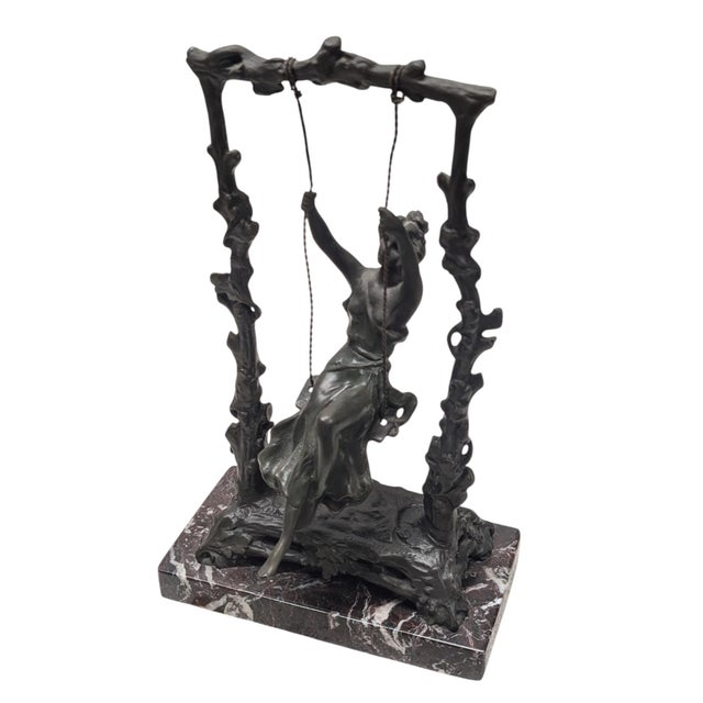 Wonderful statue in bronze by Auguste Moreau titled "Girl on a Swing". Attached to a marble base
