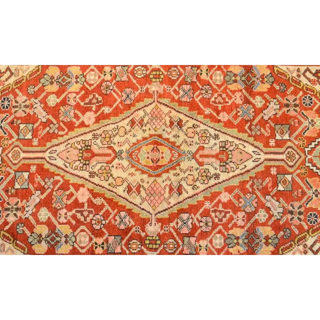 An extraordinary late 19th century Persian Serab rug with an all-over multicolored stylized floral and vine pattern on a...