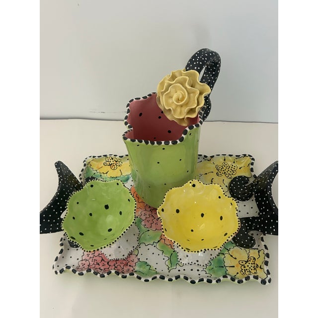 Very contemporary and unique serving set. 4 pieces include tray, pitche, and 2 compotes.