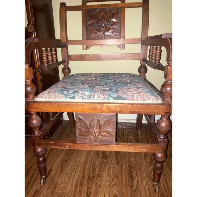 Antique parlor chair. Mahogany. Beautiful carved armrests and back seating. Very sturdy for its age. Wheels on all four legs.