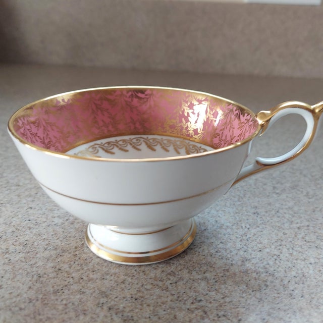 Enhance your tea-time experience with a set of one vintage Aynsley bone china tea cup and one saucer. Featuring pattern...