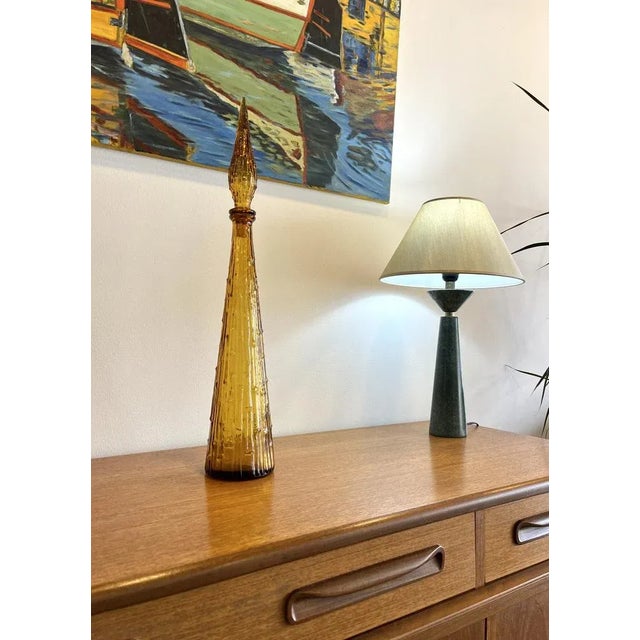 Large vintage carafe certainly from Empoli in Italy in the 60’s Nice amber color and vegetal decor Elegant with its...