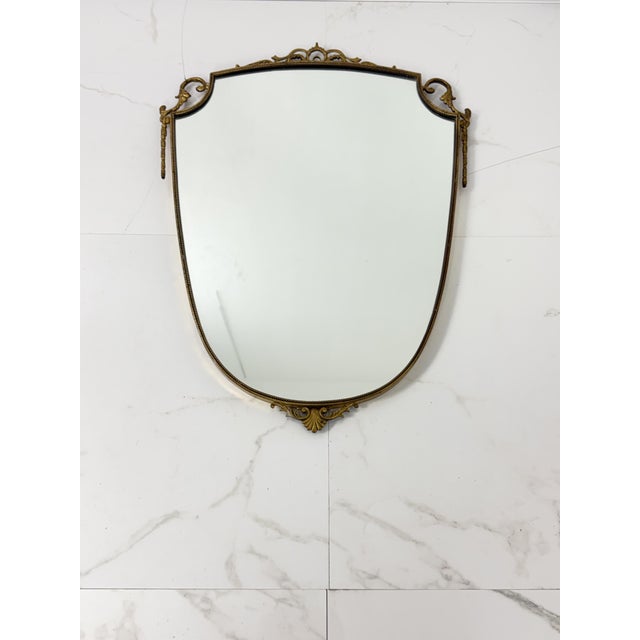Brass wall mirror, 1950s. Intact and in good condition. Small signs of wear on the brass, which was intentionally left...