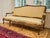 Large and sturdy sofa in the Louis XV rococo style. The sofa is subtly decorated with fine carving, profiles and curved...