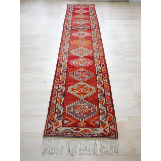 Offered is a bright Kurdish runner rug, made in Anatolia approximately 40-50 years ago. The beautiful wool on cotton pile...