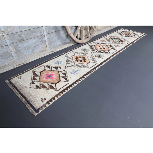 Vintage Turkish Hand-Knotted vintage rug is a semi-Vintage runner rug.'70s Eastern region of Turkey's unique rug is...