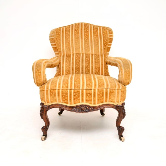 An absolutely gorgeous antique Victorian carved walnut armchair, dating from around the 1860–1880 period. This has a...