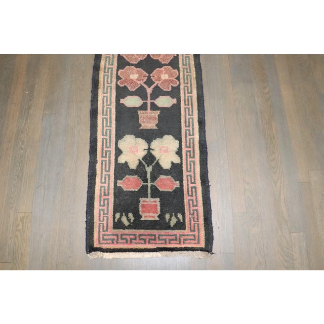 a narrow mid 20th century floral tibetan runner