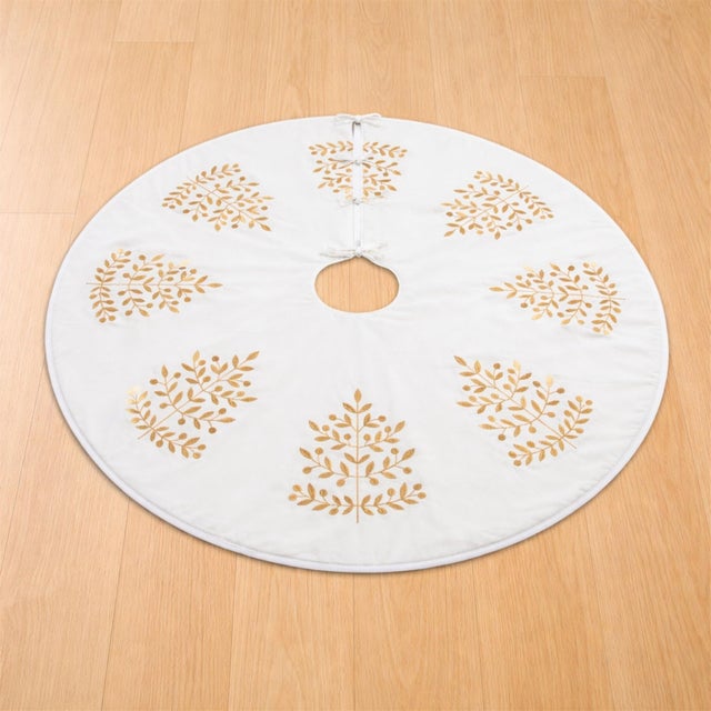 Complete your holiday tree with this elegant Christmas tree skirt featuring a repeating metallic leaf motif. The soft...