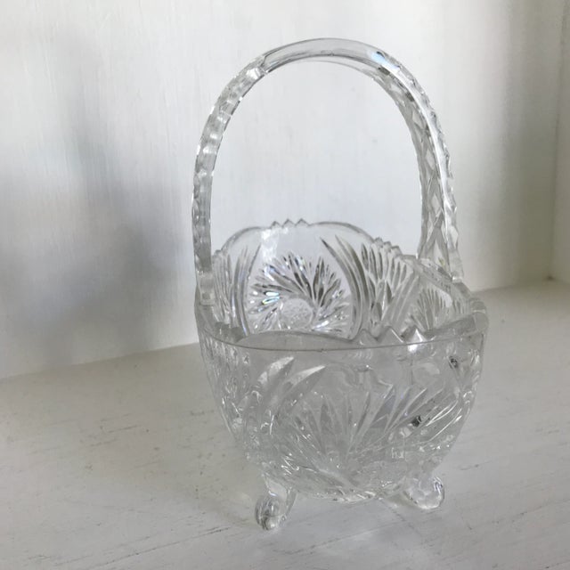 Pretty handled crystal basket. Cut crystal design with four crystal feet. Fill with your favorite candy and enjoy!
