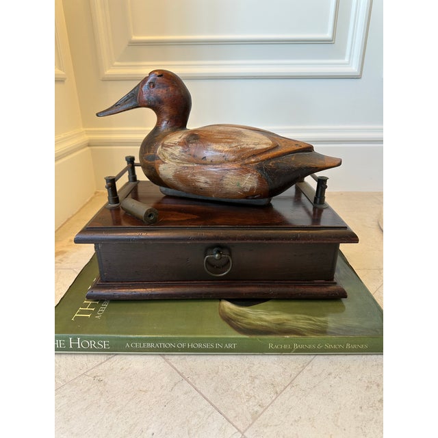 Handsome vintage duck decoy perched atop a wooden box with metal galley and drawer. Beautifully handcarved and painted...