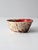 A vintage handmade studio pottery bowl featuring a richly layered glaze in vivid red with expressive speckling over a...