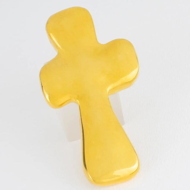A stunning cross brooch created by French designer Edouard Rambaud, Paris. The piece features a carved and textured design...