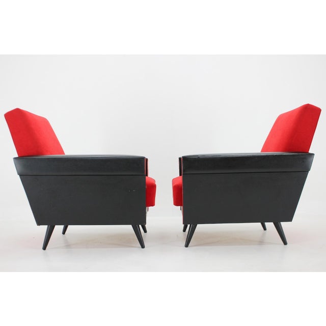 Pair of Mid-Century red and black armchairs from former Czechoslovakia. The upholstery is original in very good condition...