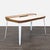 This Herman Miller desk features a clean, modern design with a smooth white surface and walnut accents. It includes a...