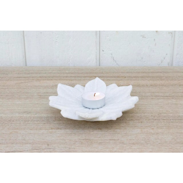 Beautiful small marble plate with carved open lotus flower motif and a warm polished finish. This Indian plate is the...