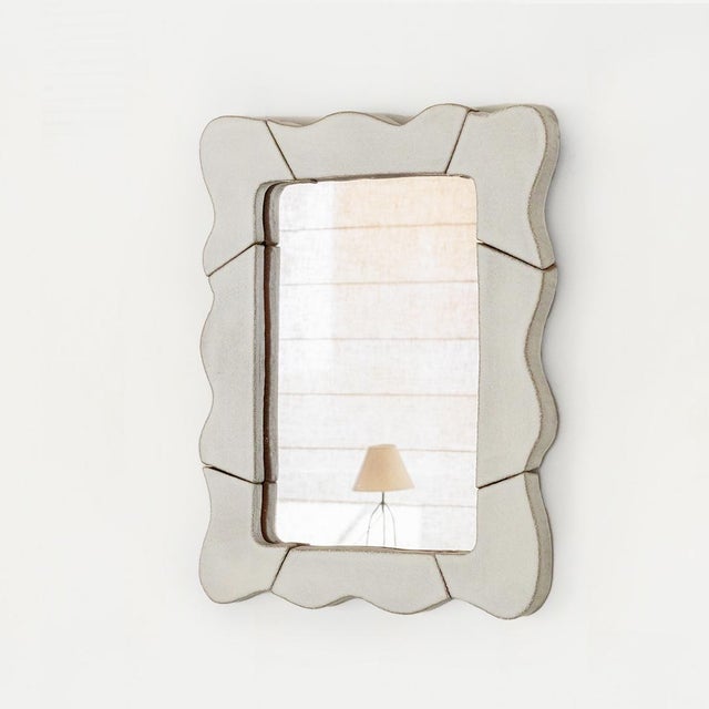 Wall mirror with wavy ceramic frame. Handmade by Morgan Peck. About the artist: Morgan Peck is a ceramicist living in Los...