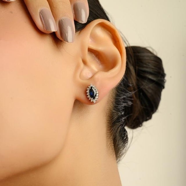 Elegant stud earrings crafted in 14K white gold, featuring 1.54 carats of deep blue marquise-cut sapphires. Each sapphire...