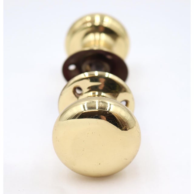 Classic style petite door knob set made of brass with a polished finish. Priced as two door knobs, two rosettes, and a...