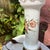 This vintage table lamp features a hand-painted floral design on white glass with a brass base and ruffled edge. It adds...