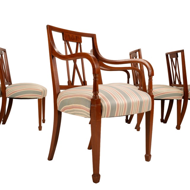 This stately set of eight Regency-style mahogany dining chairs offers a beautiful blend of craftsmanship and classic...