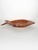 A decorative ceramic dish depicting a stylized fish, typical of 1970s design. Its expressive shape and detailed reliefs,...