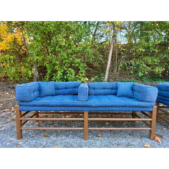 A striking pair of mid-century modern benches featuring clean-lined pine frames and tailored blue upholstered...
