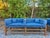 A striking pair of mid-century modern benches featuring clean-lined pine frames and tailored blue upholstered...