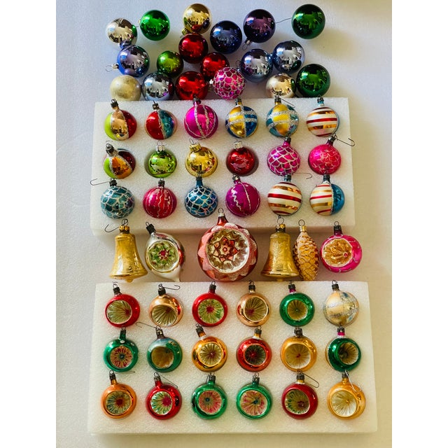 60 Vintage blown glass Christmas ornaments, with indentures, in rainbow colors and with glitter.