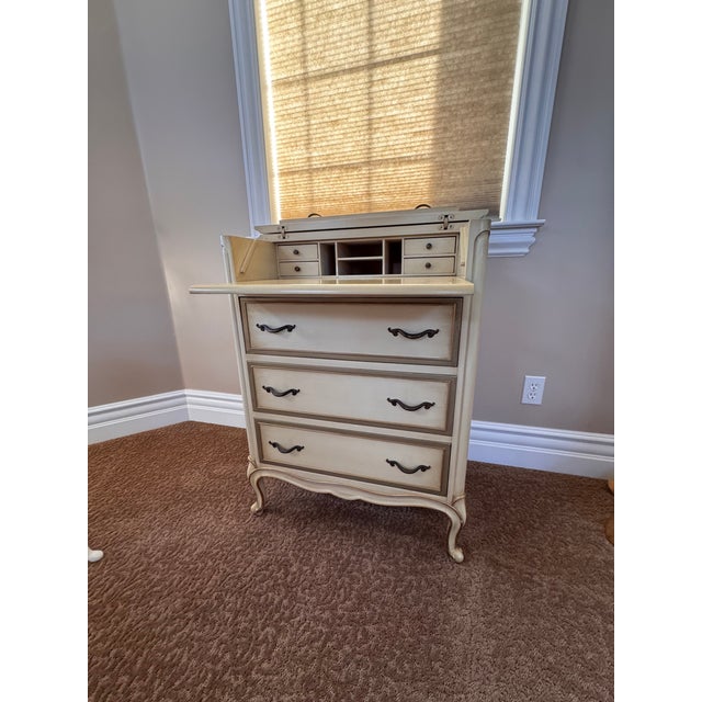 The lovely cream color with elegant handles. It looks drawers but there is a secret table.