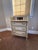 The lovely cream color with elegant handles. It looks drawers but there is a secret table.