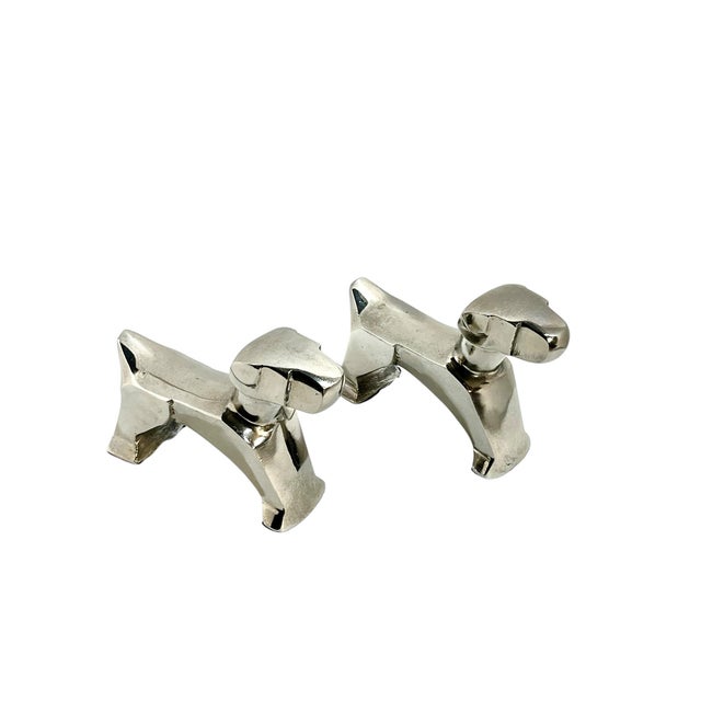Charming pair of Art Deco style chrome finish dog sculptures inspired by the work of E. Nokolsky, celebrated for his sleek...