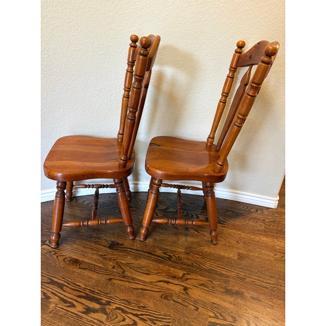 A beautifully preserved pair of authentic Cushman Colonial Creations side chairs crafted from solid maple in Bennington,...