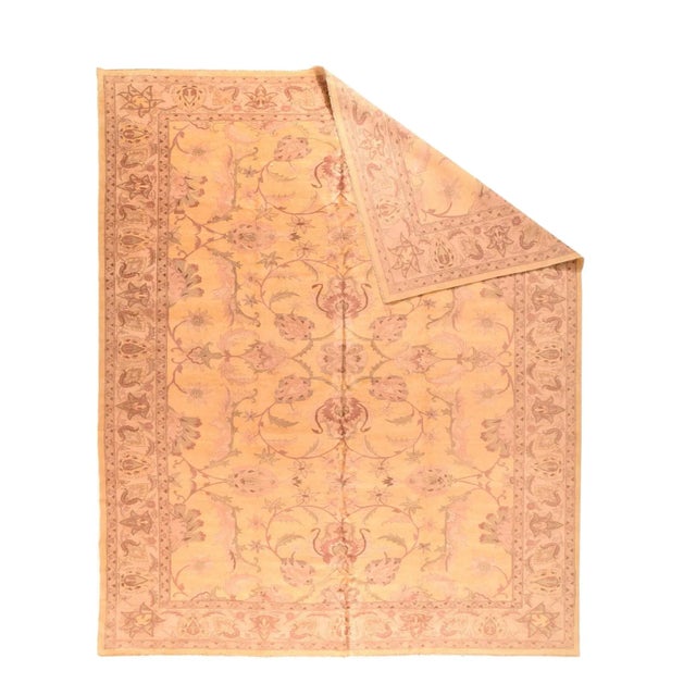 This Pakistani well-woven urban carpet shows a straw-eggshell field with a spacious pattern of palmettes and sparsely...