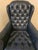 Midnight blue genuine leather, Chesterfield wingback chair. Classic deep button tufting, rolled arms, and brass nailhead...