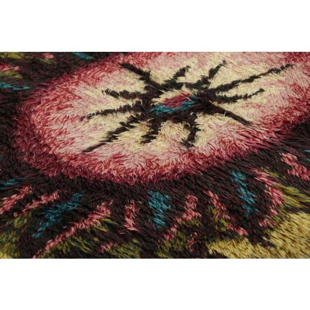 Hand-knotted in lush, high-pile wool in Sweden circa 1960-1970, this 3x5 vintage Swedish Rya rug is a bold new addition to...
