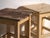 A pair of antique bedside tables in pine wood, with a square top and four tapered legs tied by box stretchers. They...