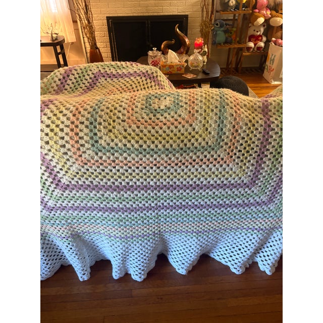 Beautiful vintage handmade continuous granny square crochet afghan featuring a classic open-work design with soft pastel...