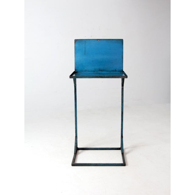 This vintage industrial metal standing desk features a tall, narrow steel frame with an original distressed blue finish....