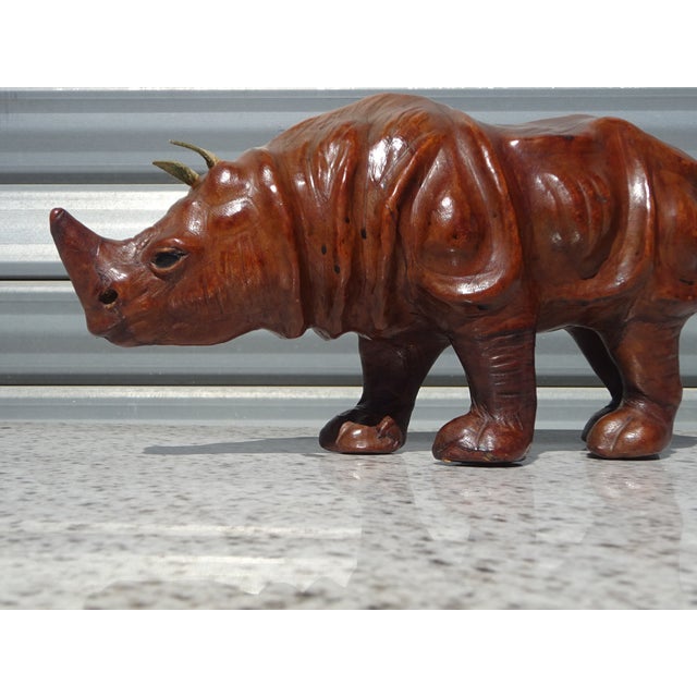 A stunning decorative piece depicting an Asian rhinoceros. This handcrafted item is distinguished by its meticulous...