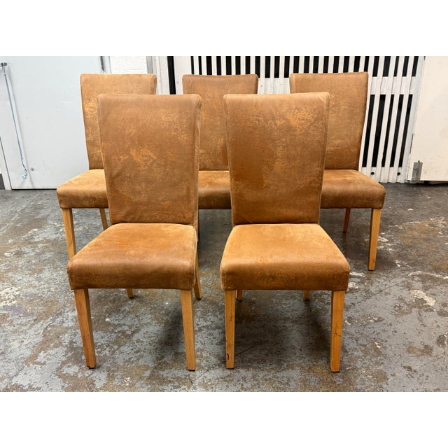 Design Plus Gallery presents a Set of Five Modern Parsons-Style Dining Chairs. Each chair has a high upholstered back,...