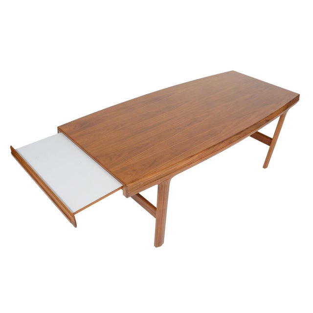 This modern mid century coffee table in walnut was Attributed to Johannes Andersen for Trensom in the 1960s. Expertly...