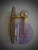 A pair of Murano wall sconces with a distinctive design, featuring a brass frame and distinctive amber and violet glass....