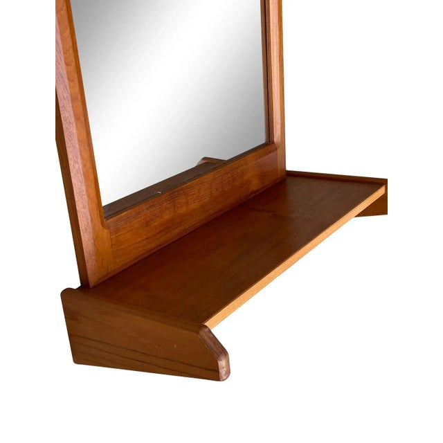 Mid Century Danish modern teak wall mirror unique Gothic arch shape with attached shelf. Made in Denmark