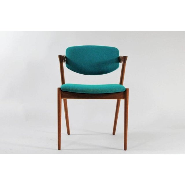 Set of eight fully restored, 1960s teak dining chairs by Kai Kristiansen for Schous Møbelfabrik. The chairs have Kai...
