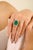 This luxury ring features a large, oval-cut emerald as the center stone, estimated to weigh 9.17 carats, surrounded by a...