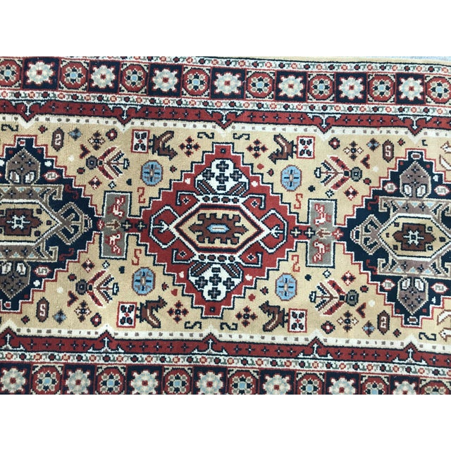 20th century Turkish rug with a geometrical design and yellow field and blue, red, brown and grey, entirely hand knotted...